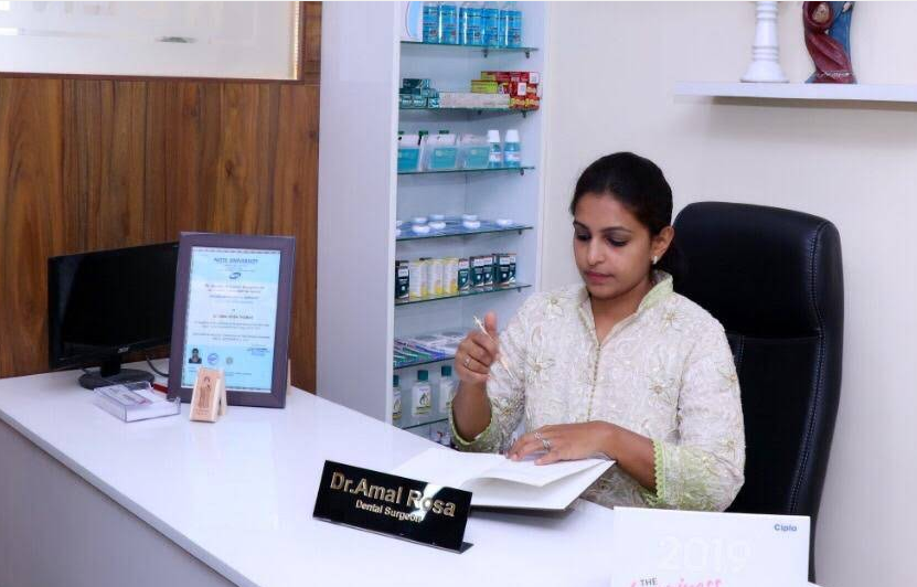Dr. Amal Rosa Thomas at her desk